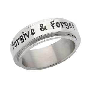 May include: A silver spinning ring with the words "forgive & forget" engraved in black lettering.