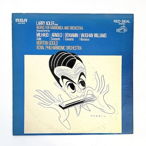 May include: A blue vinyl record album cover featuring a black and white cartoon illustration of a man playing a harmonica. The album title is "Larry Adler Plays Works for Harmonica and Orchestra" and lists the composers Milhaud, Arnold, Benjamin, and Vaughan Williams. The album is by RCA Records and is a Red Seal Stereo release.