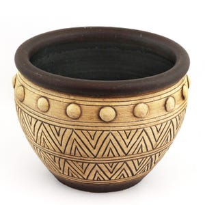 May include: A set of three ceramic mugs with a speckled, matte finish. The mugs are in shades of cream, light gray, and dark gray. Each mug has a simple, minimalist design, perfect for coffee or tea.