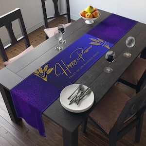 May include: Purple table runner with a gold design featuring wheat stalks and the text "Happy Passover Feast of Unleavened Bread".