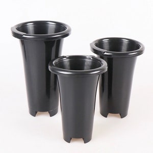 May include: Three black plastic flower vases of different sizes. The vases are tall and narrow with a flared top and a rounded bottom. They have a smooth, glossy finish.
