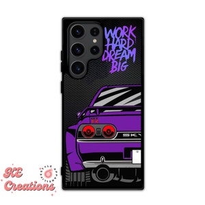 May include: Purple and black phone case with a graphic of a car's rear end and the text "WORK HARD DREAM BIG" in a gradient of pink and blue.
