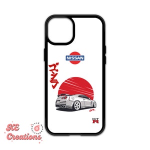 May include: White iPhone case with a red and white Japanese rising sun design, a white Nissan Skyline GT-R, and the text "Nissan" and "GT-R" in black.