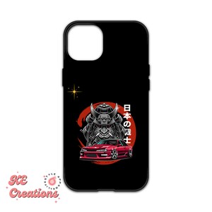 May include: A black phone case with a red and black illustration of a samurai warrior and a red sports car. The text "日本の武士" is written in Japanese on the case.