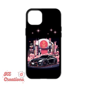 May include: Black iPhone case with a graphic of a black sports car driving through a city street at night. The city is decorated with pink and red lights and a large red circle with Japanese characters in the background.