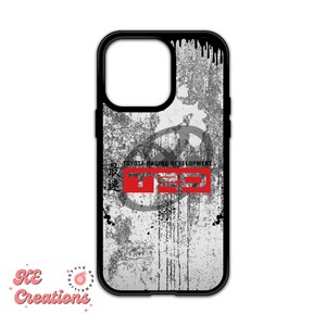 May include: A black phone case with a white and gray grunge design. The case features a red and white logo that says "TOYOTA RACING DEVELOPMENT" and "TRD".