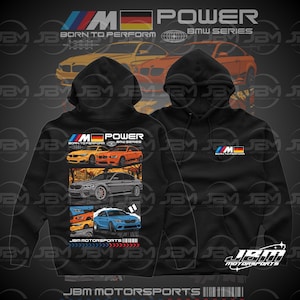 May include: Black hooded sweatshirt featuring a graphic of BMW cars in various colors. The sweatshirt has the text "M Power BMW Series" and "Born to Perform". The JBM Motorsports logo is at the bottom.