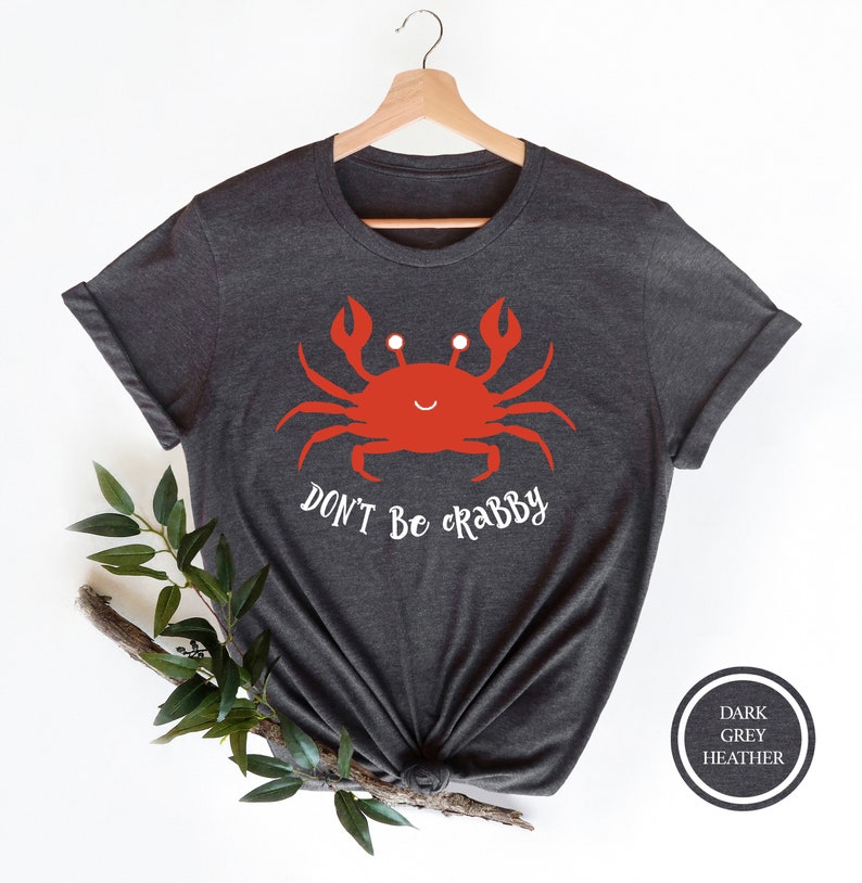 May include: A dark grey heather t-shirt with a red cartoon crab and the text "DON'T BE CRABBY".