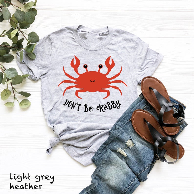 May include: Light grey heather t-shirt with a red cartoon crab and the text "Don't Be Crabby".