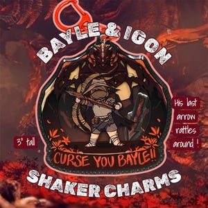 May include: A 3-inch tall shaker charm featuring a cartoon warrior with a bow and arrow, set against a dark background with a dragon. Text includes "BAYLE & IGON", "CURSE YOU BAYLE!!", and "SHAKER CHARMS". The phrase "His last arrow rattles around!" is also present.