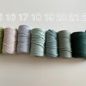May include: Eight spools of cotton cord in various shades of green, blue, and beige. The spools are labelled with numbers 15 through 22.