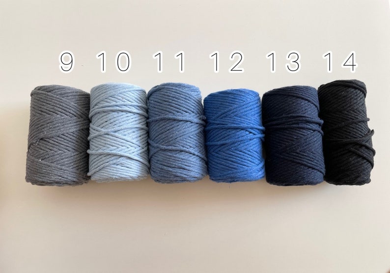 May include: Six spools of cotton cord in various shades of blue and grey. The spools are numbered 9 through 14.