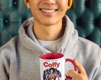 May include: White ceramic mug with a red interior and handle. The mug features a movie poster design with the text "Pam Grier - Coffy" and a vintage illustration of a woman holding a gun.