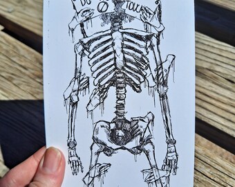 May include: A black and white ink drawing on a rectangular card featuring a skeleton with multiple arms and hands. The skeleton holds a sign that reads DO NOT TOUCH with a prohibition symbol. The lines are sketchy with a dripping, fluid effect.