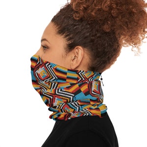 May include: A colorful face mask with a geometric pattern in shades of blue, red, yellow, and black. The mask is made of a breathable fabric and has a drawstring closure.