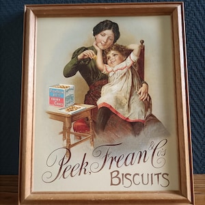 Tablero de madera con un antiguo cartel publicitario de las galletas Peak Frean & Co. en estilo vintage • Póster enmarcado • Ilustración publicitaria