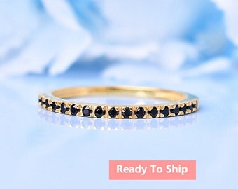 May include: A delicate gold band ring with a row of black diamonds encircling the band.  Ready To Ship.