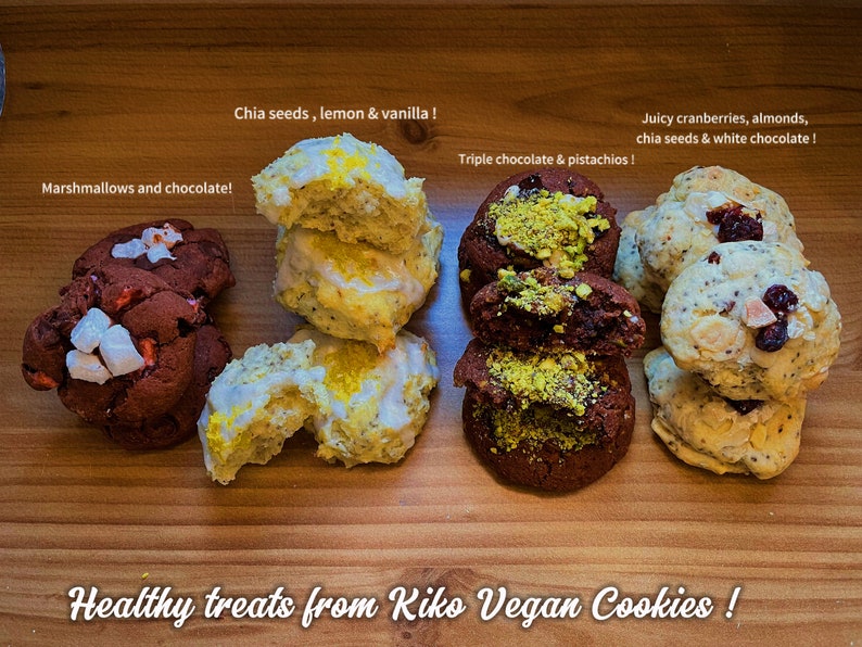 May include: Four different types of vegan cookies on a wooden surface. The cookies are arranged in four rows. The first row is a red cookie with white marshmallows and chocolate chips. The second row is a yellow cookie with lemon and vanilla. The third row is a brown cookie with chocolate and pistachios. The fourth row is a white cookie with cranberries, almonds, chia seeds, and white chocolate. The text "Healthy treats from Kiko Vegan Cookies!" is written below the cookies.