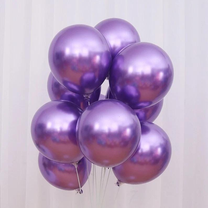 May include: A bunch of purple metallic balloons. The balloons are shiny and reflect light.