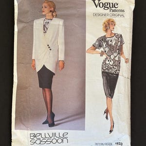 May include: A Vogue Patterns Designer Original sewing pattern envelope, number 1833, featuring Bellville Sassoon designs. The front displays illustrations of a white blazer with a black skirt and a black and white floral print top with a black skirt.