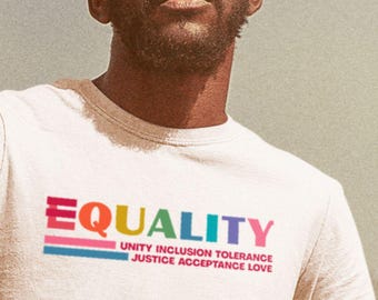 May include: A white t-shirt with the word "EQUALITY" printed in rainbow colors. The text "UNITY INCLUSION TOLERANCE JUSTICE ACCEPTANCE LOVE" is printed in black below the word "EQUALITY".