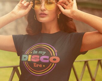 May include: A black t-shirt with a colorful graphic that says "In my Disco Era" in a retro font.