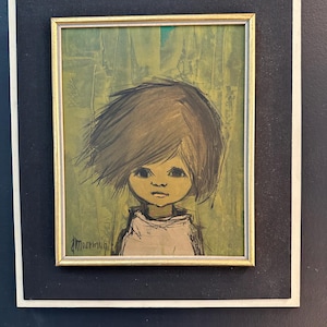 May include: A framed vintage artwork featuring a stylized child's portrait. The painting has a green and yellow background, a gold frame, and a black mat. The child has brown hair and is wearing a white garment. The artist's signature is visible.