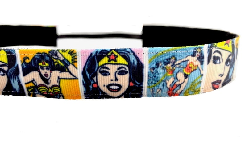 May include: A black headband with a colorful Wonder Woman comic book print. The print features Wonder Woman in various poses and expressions.