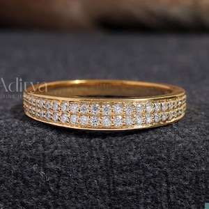 以下が含まれることがあります： 2列の小さな透明なダイヤモンドが施されたゴールドのバンドリングです。