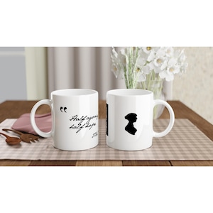 Puede incluir: Dos tazas de cerámica blanca con texto negro y una silueta. Una taza dice "Half agony, half hope." La otra taza tiene una silueta de una mujer con un gorro.