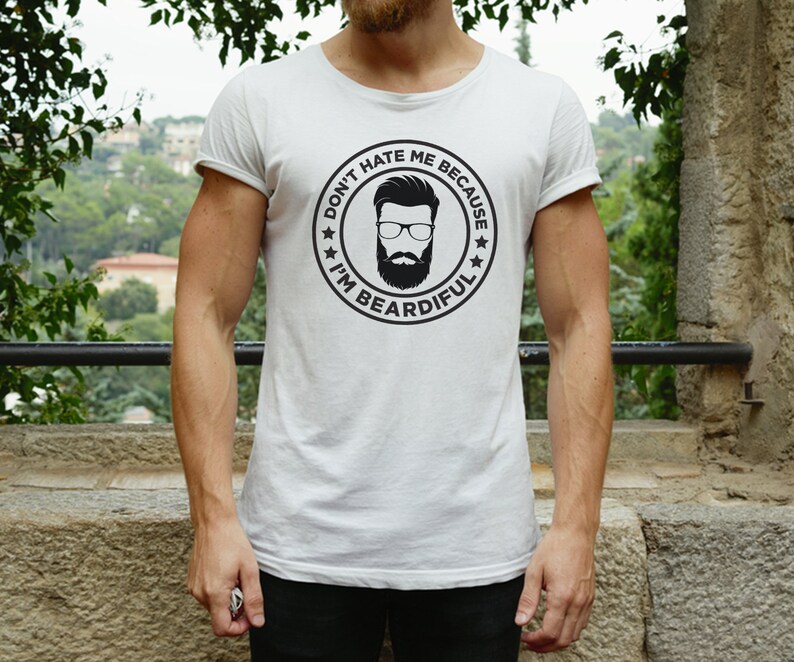 May include: White t-shirt with a black and white graphic of a man with a beard and the text "Don't hate me because I'm beardful."