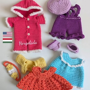 May include: A set of crocheted doll clothes, including a pink hooded jacket, purple overalls, a light blue dress, an orange dress, a yellow dress, a purple beret, and a pair of purple shoes. The text "Horgoláda" is embroidered on the pink jacket.