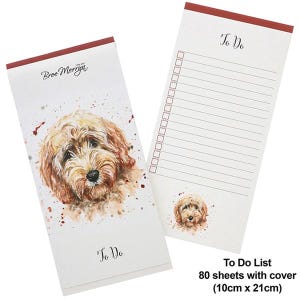 May include: Two white notepads with a watercolor illustration of a dog's face. The notepads have a red border at the top and the words "To Do" printed on them. The notepad on the right has a to-do list format. The notepads are 10cm x 21cm.