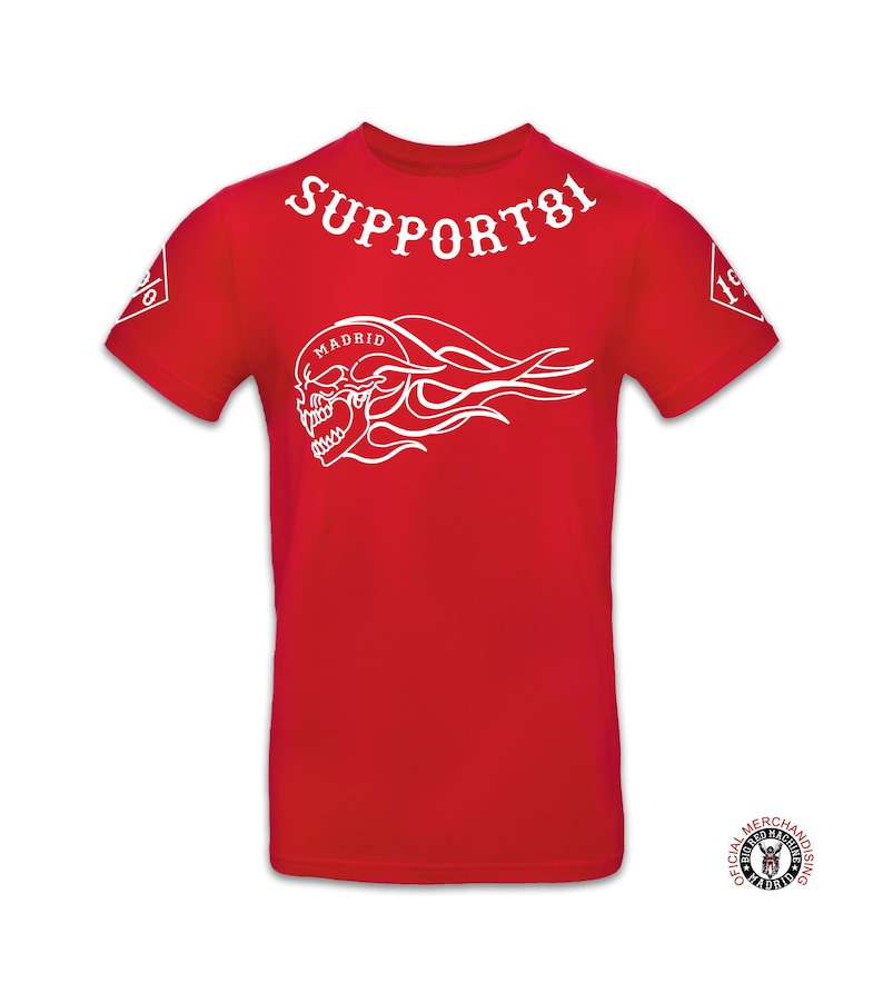 May include: Red t-shirt with a white skull and flames graphic, the text "SUPPORT 81" and "MADRID" on the front. The text "OFFICIAL MERCHANDISING" is on a black circle with a white skull logo.