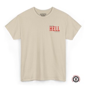 A beige t-shirt with the text "See you in Hell" in red lettering. The text "Support81 Madrid" is printed in black and red.