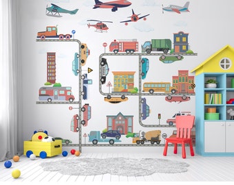 May include: A colorful wall decal featuring a city scene with roads, buildings, and various vehicles, including cars, trucks, buses, and airplanes. The design incorporates a playful arrangement of elements, with a child's room setting in the background.