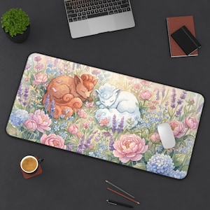 May include: A rectangular desk mat featuring a watercolor illustration of two sleeping fox-like creatures amidst a field of pink peonies, lavender, and blue hydrangeas. A white mouse rests on the mat.