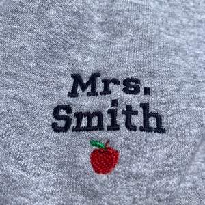 Custom embroidered Teacher sweatshirt with name on sleeves