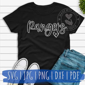 May include: A black t-shirt with the word "Rangers" in white outlined text with a small heart next to it. The shirt is on a white wood surface with a pair of white sneakers and blue jeans. The text "SVG I JPG I PNG I DXF I PDF" is at the bottom of the image. A small circle with the text "MADE WITH LOVE HAND MADE" is in the top right corner of the image.
