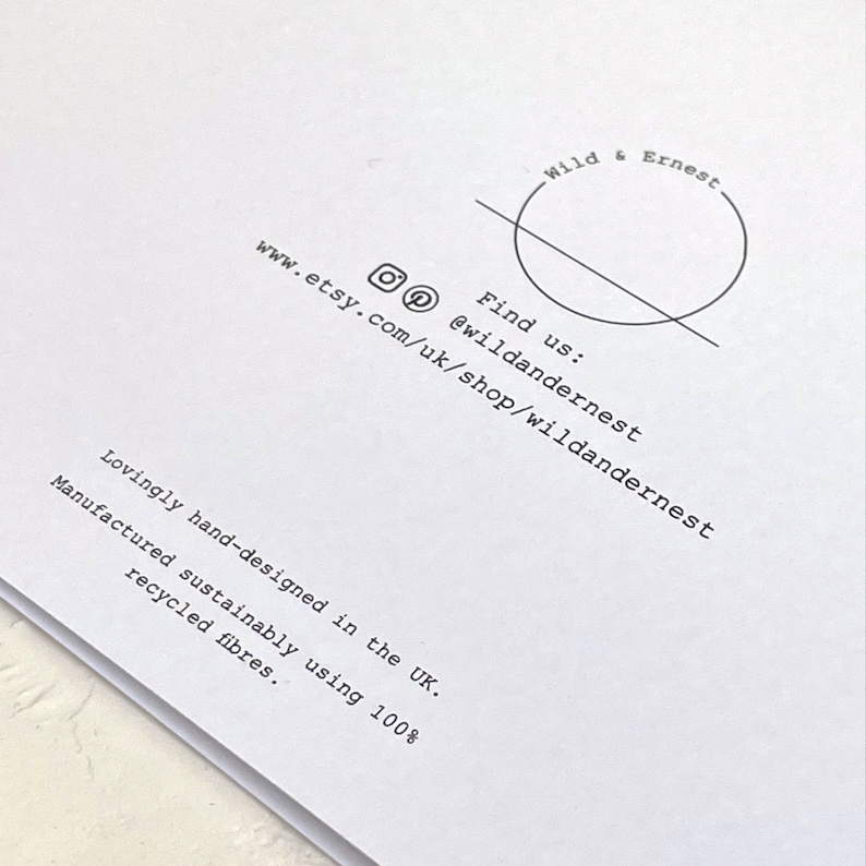May include: A white card with black text that reads "Wild & Ernest" in a circle with a line through it. The text also reads "Find us: @wildandernest www.etsy.com/uk/shop/wildandernest Lovingly hand-designed in the UK. Manufactured sustainably using 100% recycled fibres."