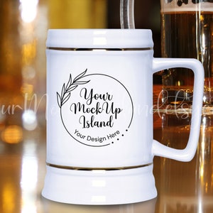 May include: White ceramic beer stein with a gold rim and a black circle design that says "Your Mock Up Island" and "Your Design Here".