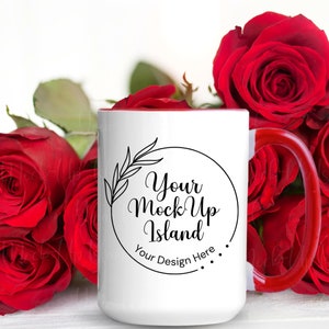 May include: White ceramic mug with a red rim and handle. The mug has a black circle with the text "Your Mock Up Island" and "Your Design Here" in a cursive font. The mug is surrounded by red roses.