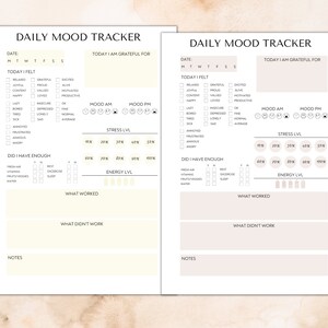 May include: Two pages of a daily mood tracker printable. The pages are beige with black text and checkboxes. The top of each page says "Daily Mood Tracker". The left page has a section for "Today I Felt" with checkboxes for feelings like relaxed, joyful, happy, and annoyed. The right page has a section for "Today I Felt" with checkboxes for feelings like relaxed, joyful, happy, and annoyed. Both pages have sections for "Today I Am Grateful For", "Mood AM", "Mood PM", "Stress Lvl", "Did I Have Enough", "Energy Lvl", "What Worked", "What Didn't Work", and "Notes".