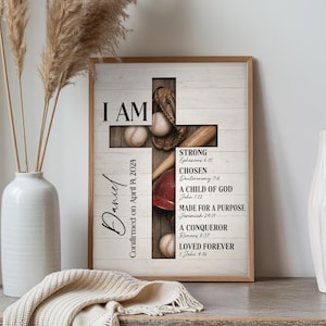 May include: Framed wooden wall art featuring a cross design with baseball elements. The cross is made of wood planks, with a baseball glove, baseballs, and a bat. Text includes "I AM" and Bible verses. Personalized with the name "Daniel" and date "April 14, 2024".