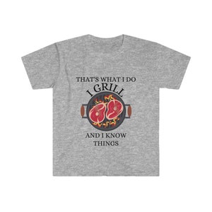 May include: Gray t-shirt with a graphic of a grill with two steaks on it. The text "That's what I do I grill and I know things" is printed on the shirt.