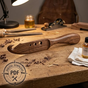 May include: A white ceramic mug with a black handle and the text "But First, Coffee" in a black, handwritten-style font. The mug is on a white surface.