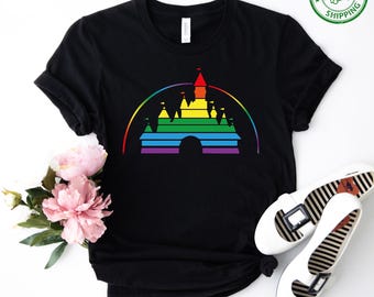 May include: Black t-shirt with a rainbow-colored silhouette of a castle. The castle is outlined in black and has a rainbow arch above it.