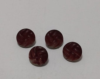 May include: Four brown round buttons with a woven pattern.