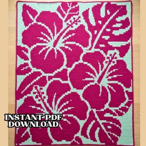 May include: A handmade crochet blanket featuring a vibrant hibiscus flower design in shades of fuchsia and light teal. The blanket has the text "INSTANT PDF DOWNLOAD" in the lower left corner. The floral pattern is a repeating motif.