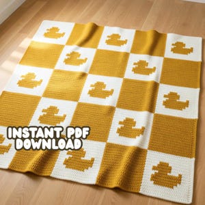 May include: A handmade crochet blanket with a checkerboard pattern of mustard yellow and white squares. Each yellow square features a duck design. The text "INSTANT PDF DOWNLOAD" is visible at the bottom of the blanket.